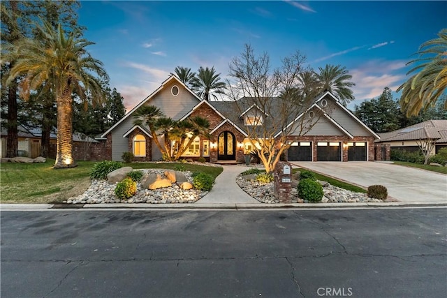 view of front facade with a front lawn, a garage, and driveway