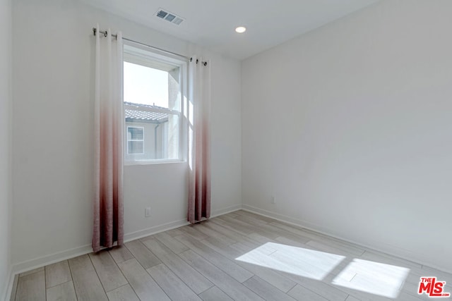 spare room with light wood-type flooring