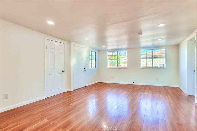 unfurnished room with light wood-type flooring