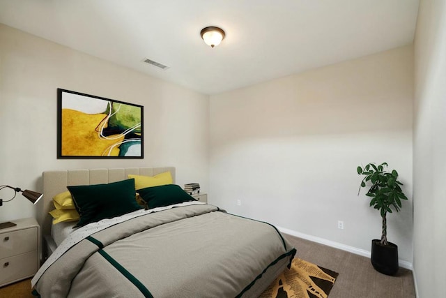 bedroom with dark colored carpet