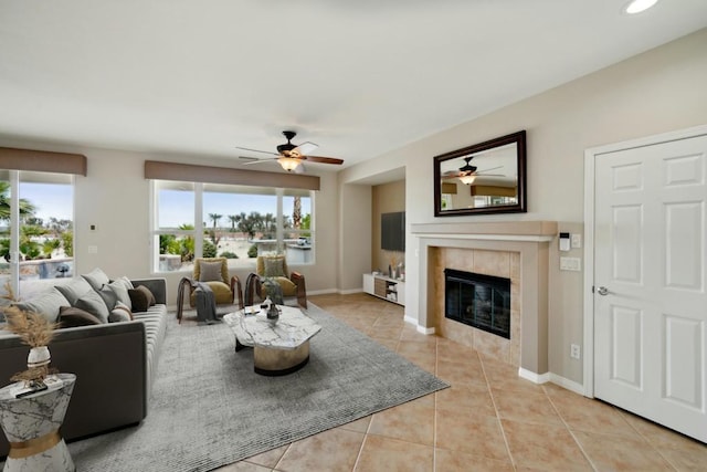 tiled living room with a tiled fireplace and ceiling fan