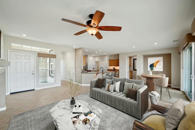 tiled living room with sink and ceiling fan