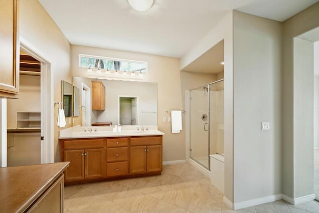 bathroom with vanity and a shower with door