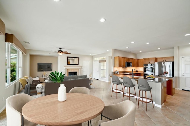 tiled dining room with ceiling fan