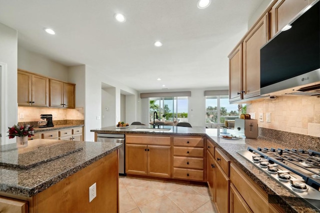 kitchen with sink, decorative backsplash, a center island, and appliances with stainless steel finishes