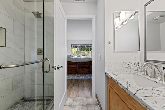 bathroom featuring walk in shower and vanity