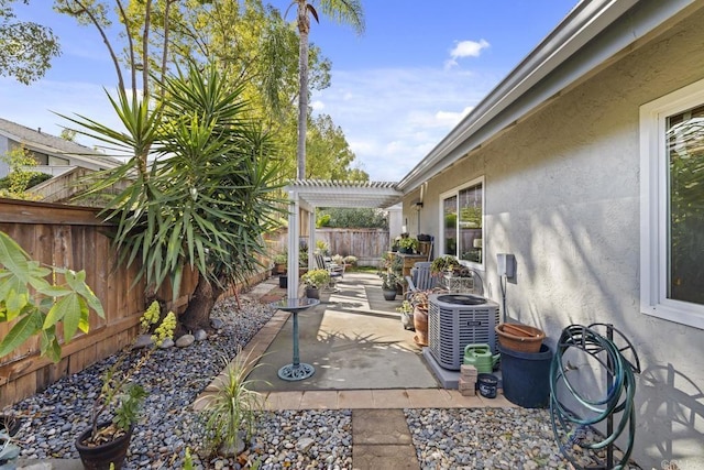 view of patio / terrace with central AC unit and a pergola