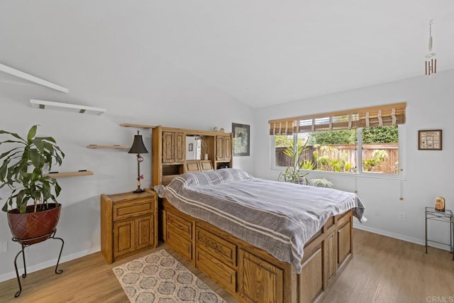 bedroom featuring light hardwood / wood-style flooring and vaulted ceiling