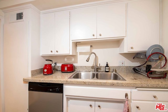 kitchen featuring stainless steel dishwasher, sink, and white cabinets