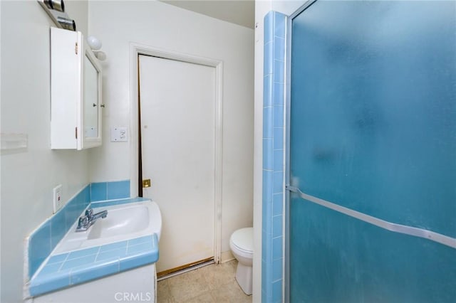 bathroom with vanity, an enclosed shower, and toilet