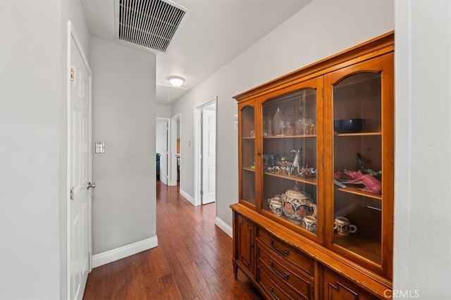 hallway with dark wood-type flooring