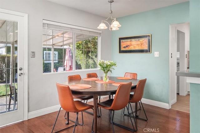 dining space featuring dark hardwood / wood-style floors and a notable chandelier