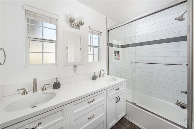 bathroom featuring enclosed tub / shower combo and vanity