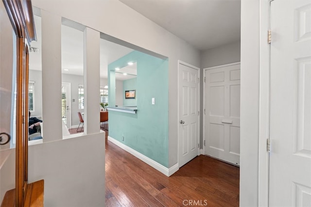 hallway with dark hardwood / wood-style flooring