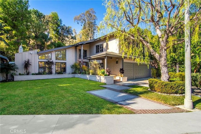 view of front facade with a garage and a front lawn