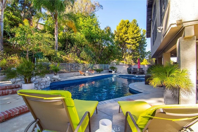 view of pool featuring a jacuzzi and a patio