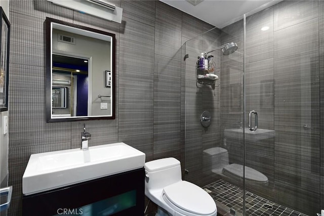 bathroom featuring walk in shower, vanity, and toilet