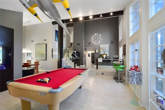 game room featuring a towering ceiling and billiards