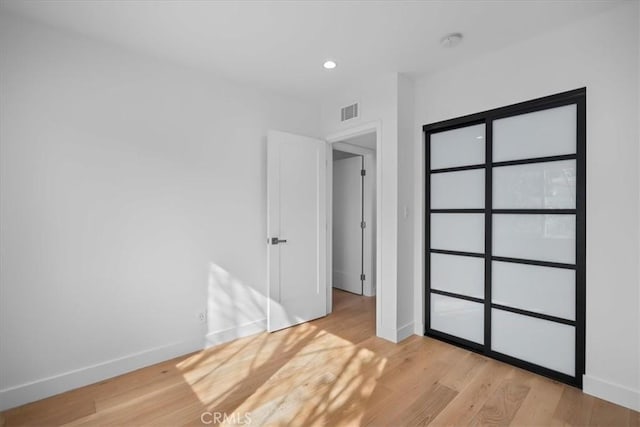 unfurnished bedroom featuring light wood-type flooring