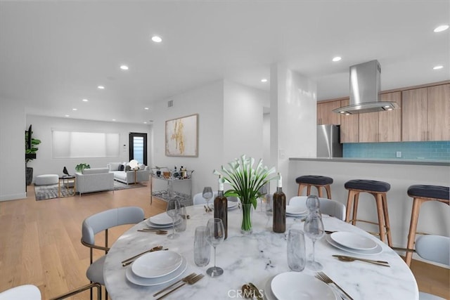 dining space featuring light wood-type flooring