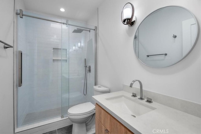 bathroom featuring vanity, tile patterned floors, toilet, and walk in shower