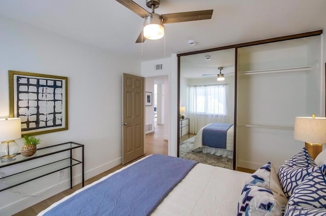 bedroom with ceiling fan and a closet