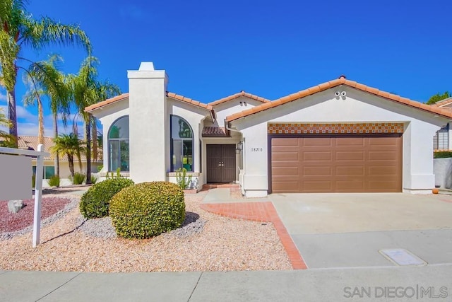 mediterranean / spanish-style home with a garage