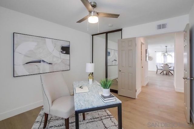 home office featuring ceiling fan and light hardwood / wood-style flooring