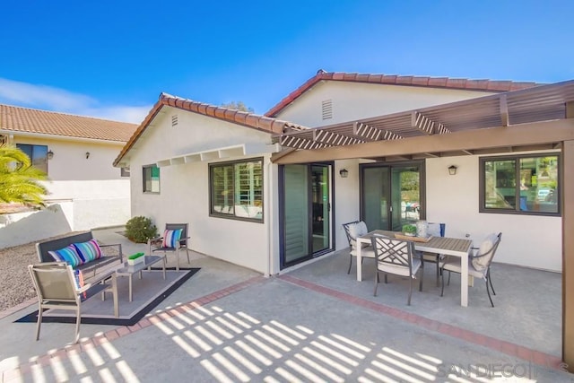 back of property featuring a patio, outdoor lounge area, and a pergola