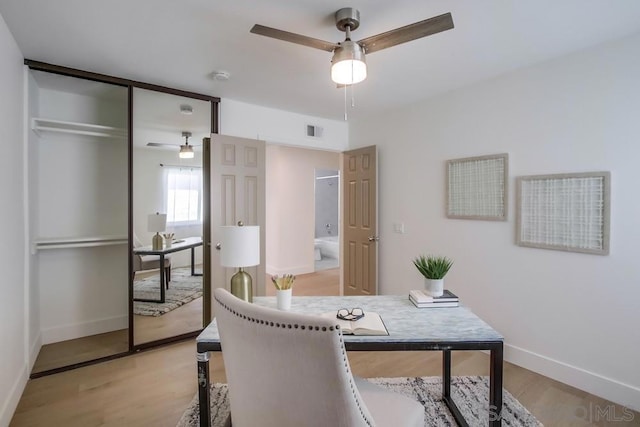 office space featuring ceiling fan and light hardwood / wood-style flooring