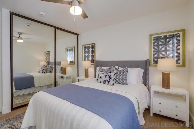 bedroom with ceiling fan, hardwood / wood-style floors, and a closet