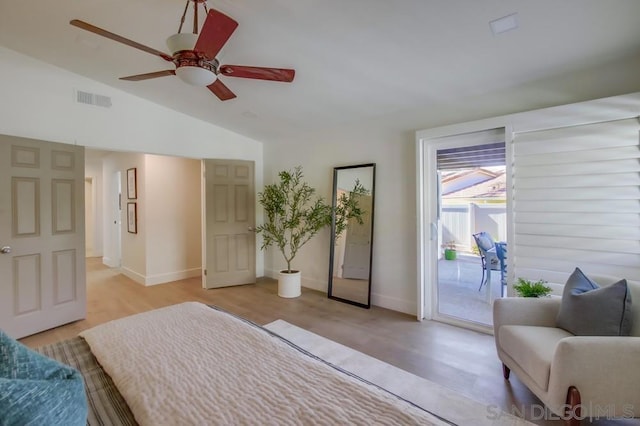 bedroom with vaulted ceiling, ceiling fan, access to exterior, and light hardwood / wood-style floors