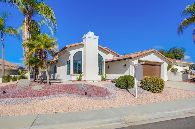 mediterranean / spanish-style house featuring a garage