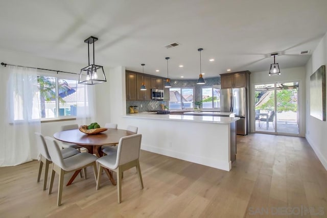 dining room with light wood-type flooring