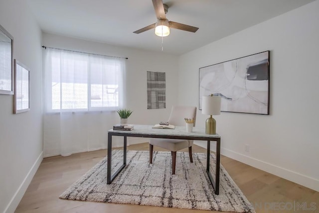 home office with ceiling fan and light wood-type flooring