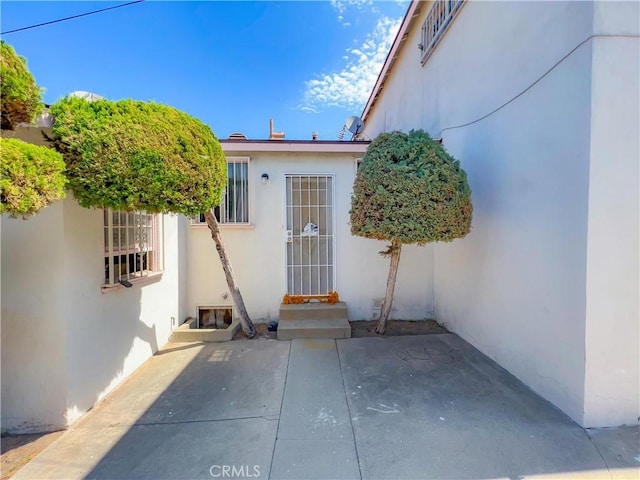 entrance to property with a patio