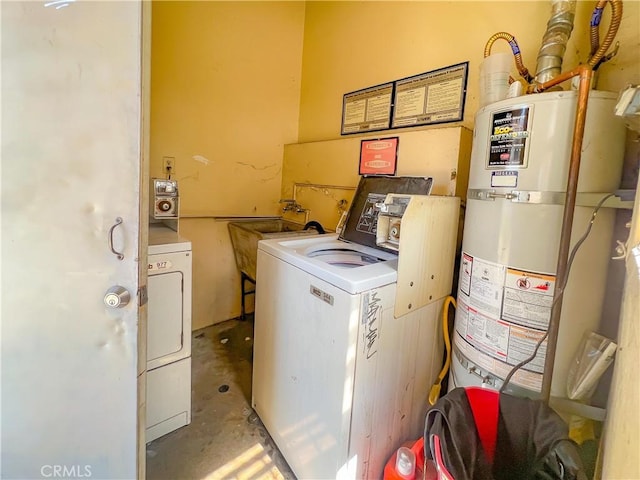 laundry room with water heater, washing machine and dryer, and sink