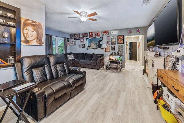 living room featuring ceiling fan and light wood-type flooring