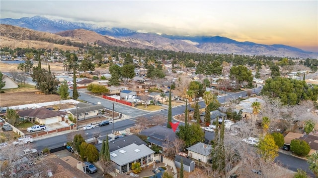 aerial view at dusk featuring a mountain view