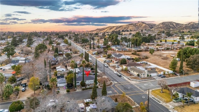 aerial view at dusk featuring a mountain view