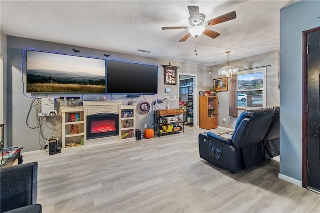 living room with wood-type flooring and ceiling fan