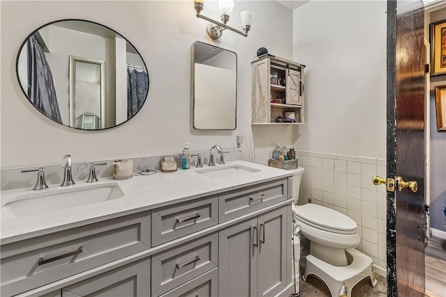 bathroom featuring tile walls, vanity, and toilet