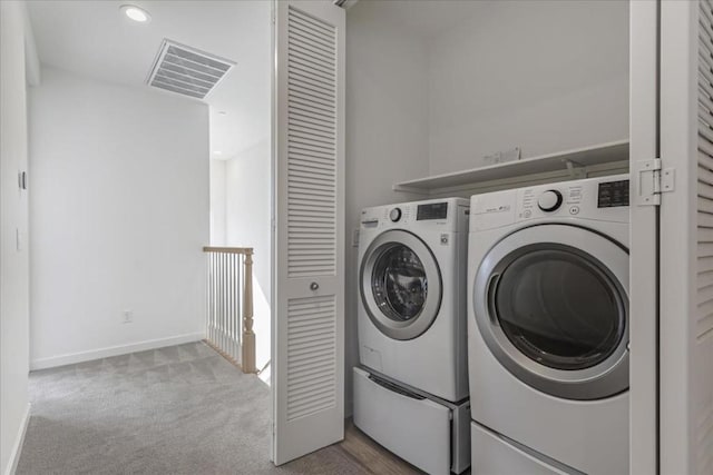 laundry area featuring light colored carpet and independent washer and dryer