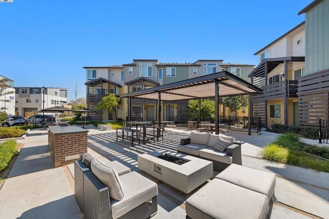 view of patio / terrace with an outdoor living space with a fire pit