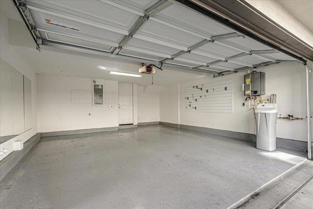 garage with a garage door opener and electric panel