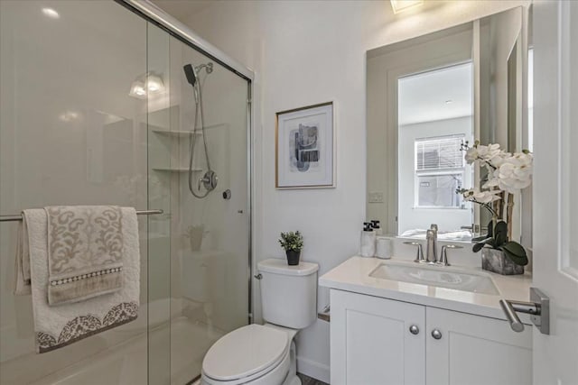 bathroom featuring vanity, toilet, and walk in shower