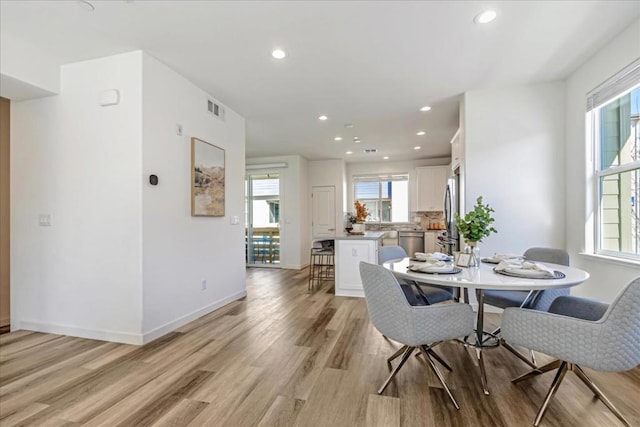 dining space with light hardwood / wood-style floors