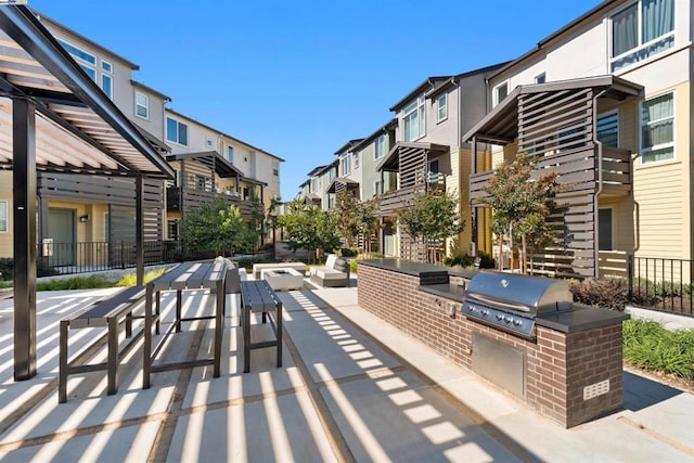 view of property's community featuring area for grilling and a patio area