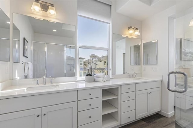 bathroom featuring vanity, hardwood / wood-style floors, and a shower with door