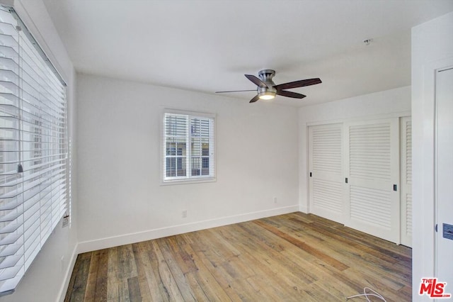 unfurnished bedroom featuring hardwood / wood-style floors and ceiling fan